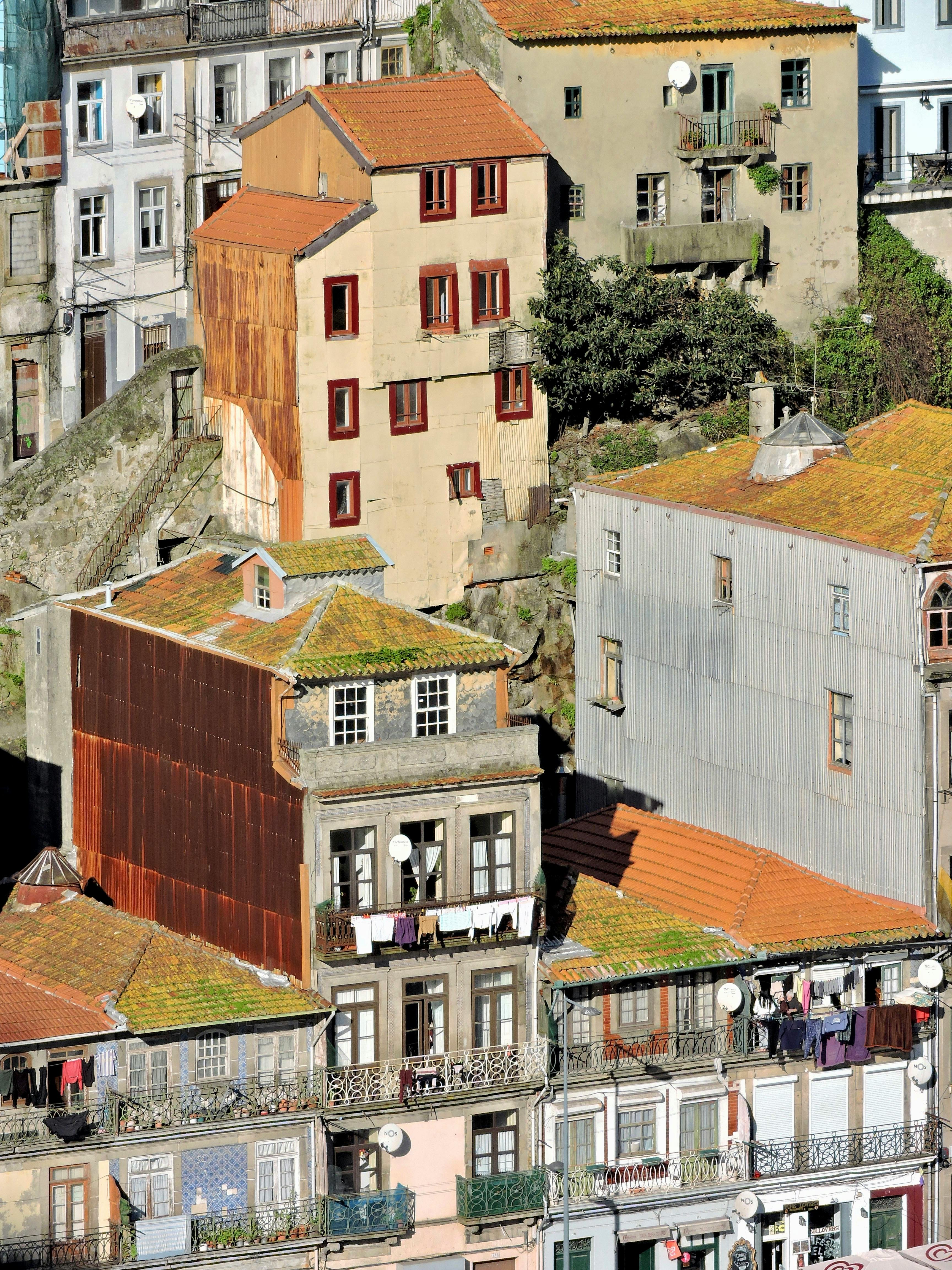 Aerial view of colorful historic buildings in Porto, Portugal, with vibrant rooftops.