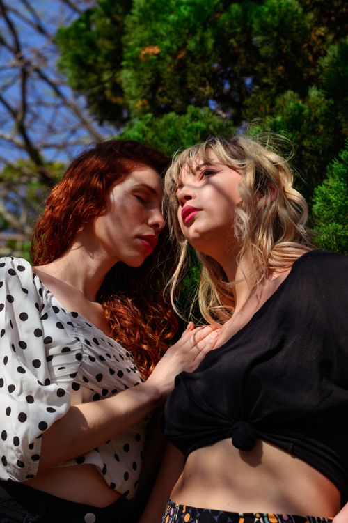 Free Fashionable outdoor portrait of two women embracing in sunlight in Belo Horizonte. Stock Photo