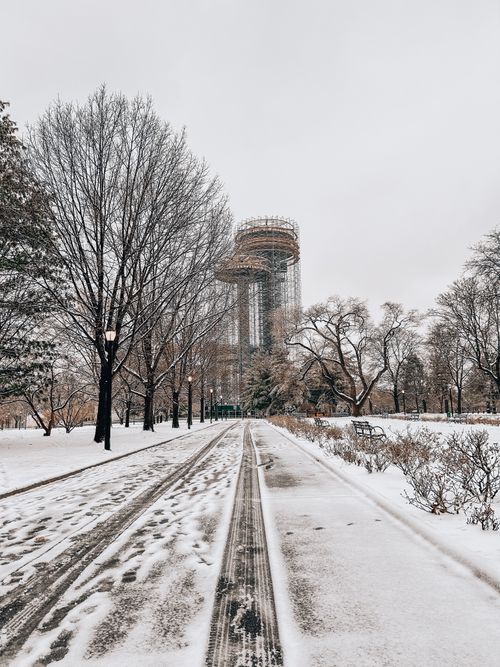 Free Snow-covered scene featuring the New York State Pavilion with bare winter trees. Stock Photo
