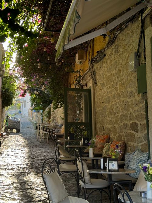 Free Quaint outdoor cafe in a cobblestone alleyway, Alacati, Turkey. Stock Photo