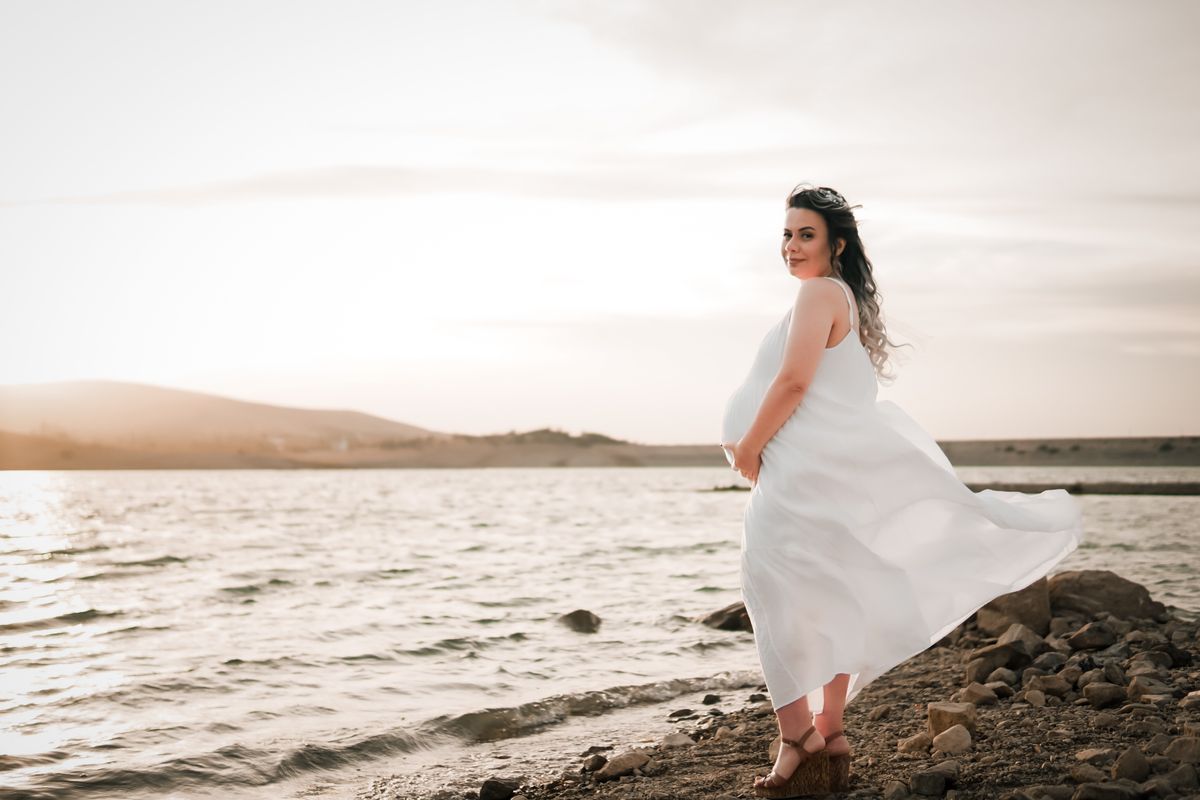 maternity dress hire cost Australia — pregnant woman white dress pricing guide Melbourne pregnancy gown hire from $40 Craigieburn