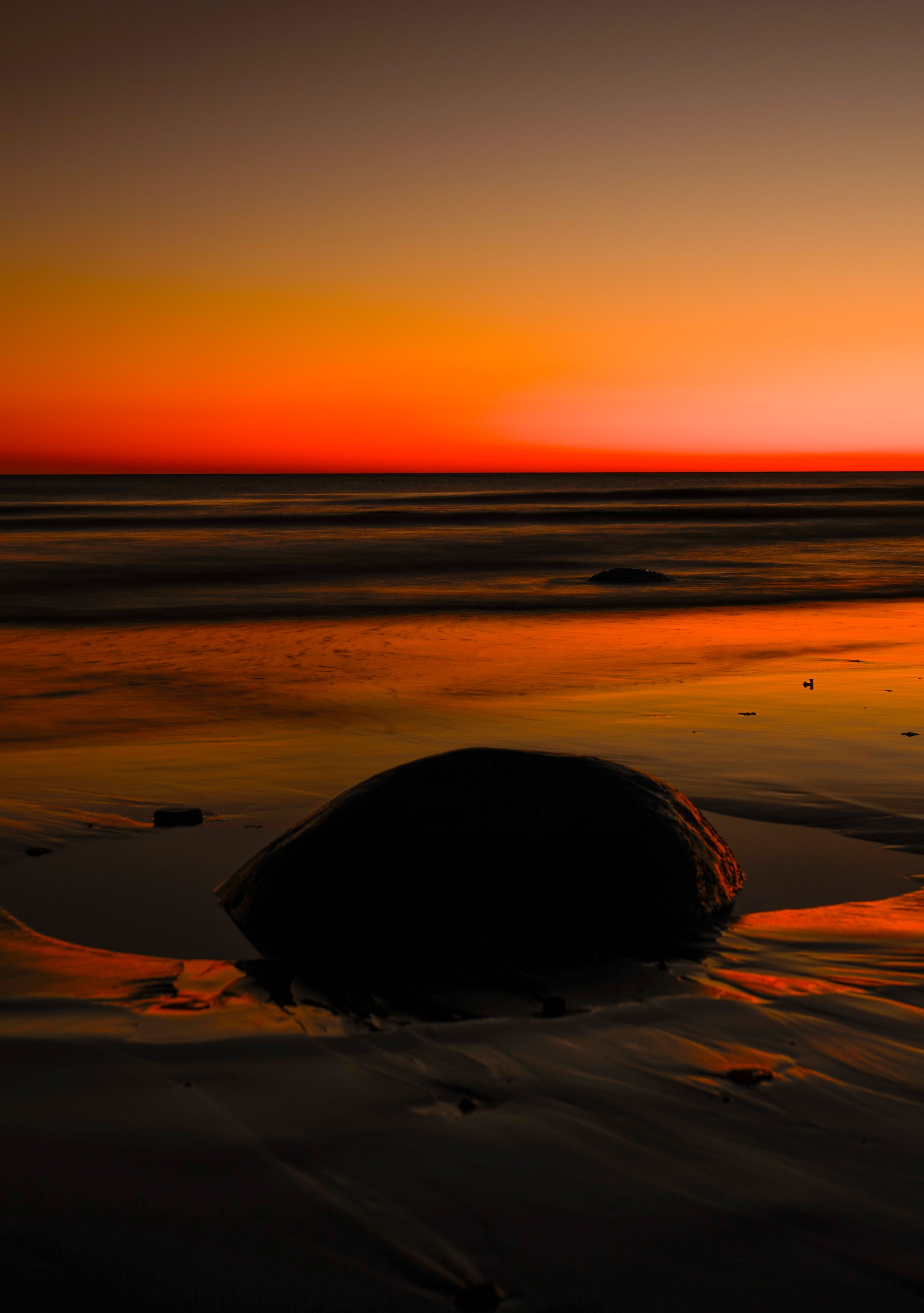 Scenic Sunset Over Coastal Beach with Rock · Free Stock Photo