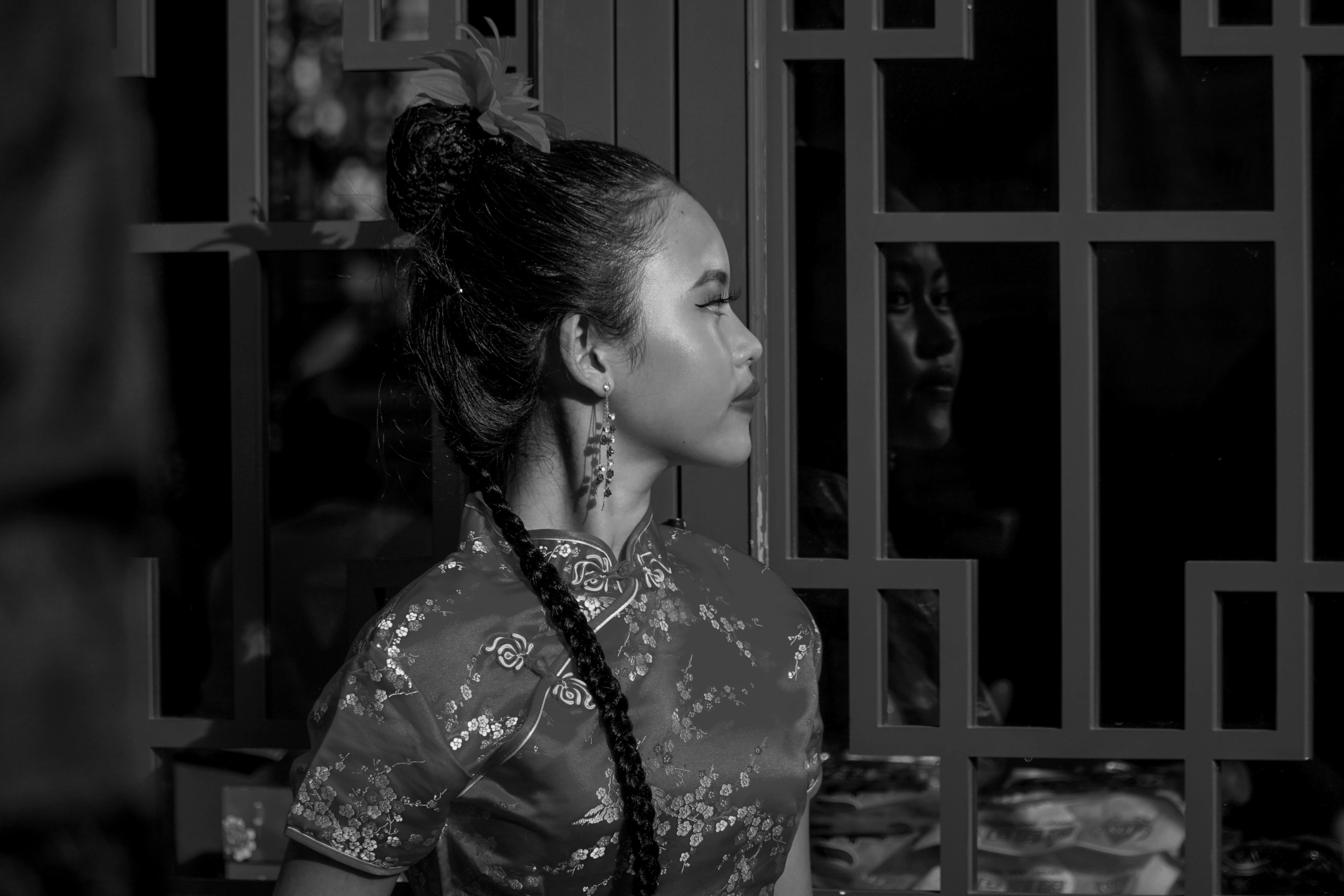 Black and white portrait of a woman in traditional attire, Jakarta setting.