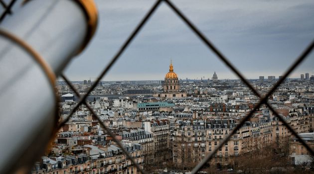 Stunning view of Paris skyline through lattice, featuring Les Invalides.