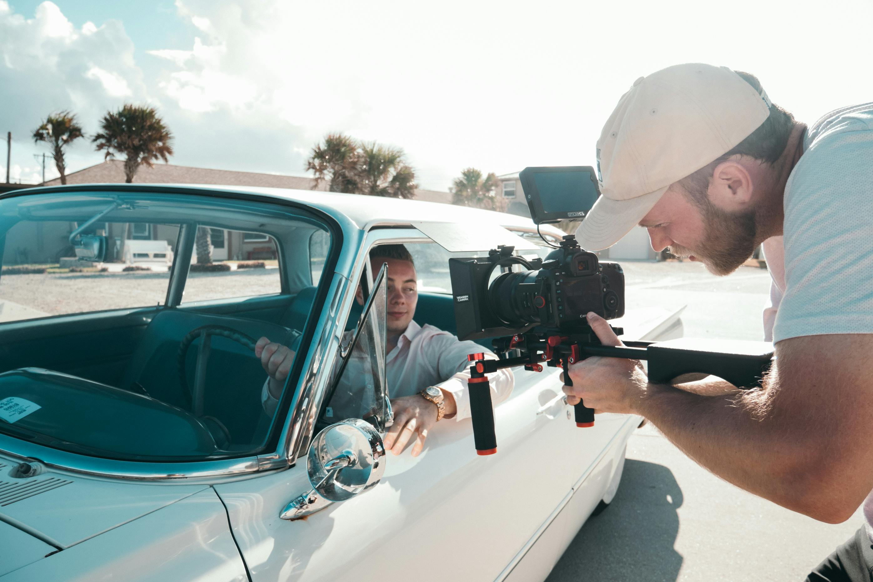 A person recording a car and its driver