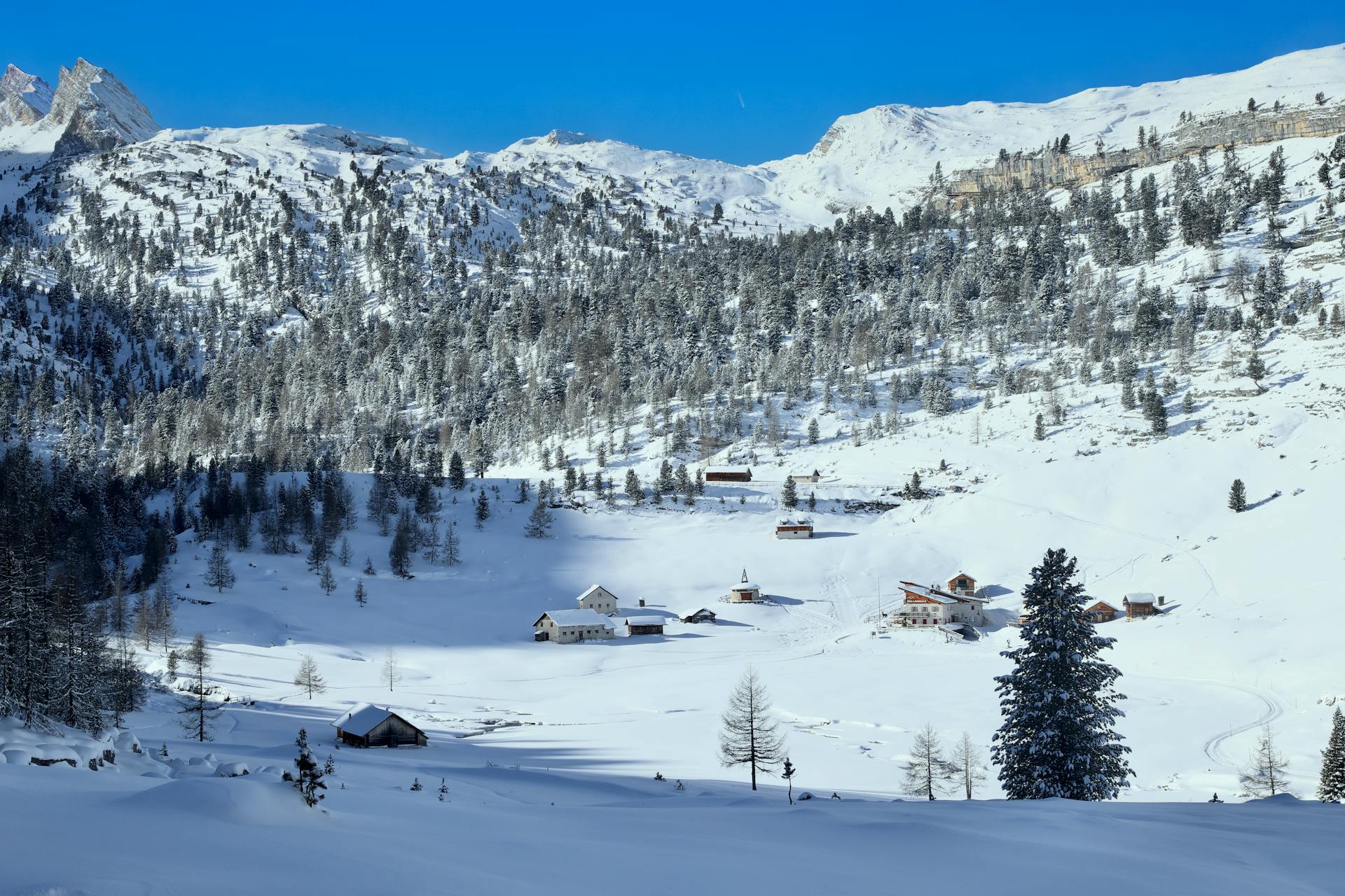 Picturesque snowy valley in San Vigilio, Trentino-Alto Adige, Italy with rustic chalets.