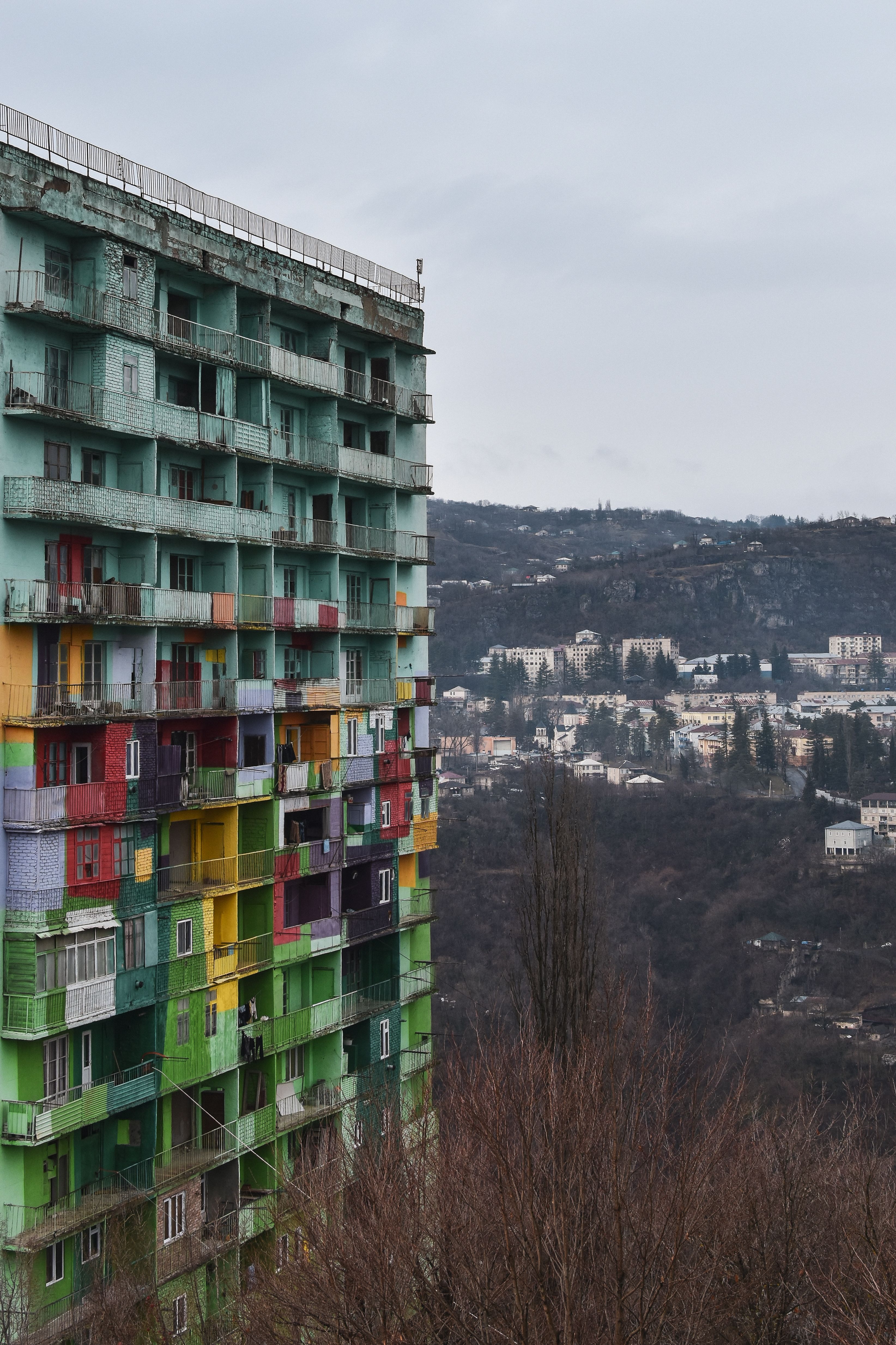 Vibrant Building Against Mountain Backdrop · Free Stock Photo