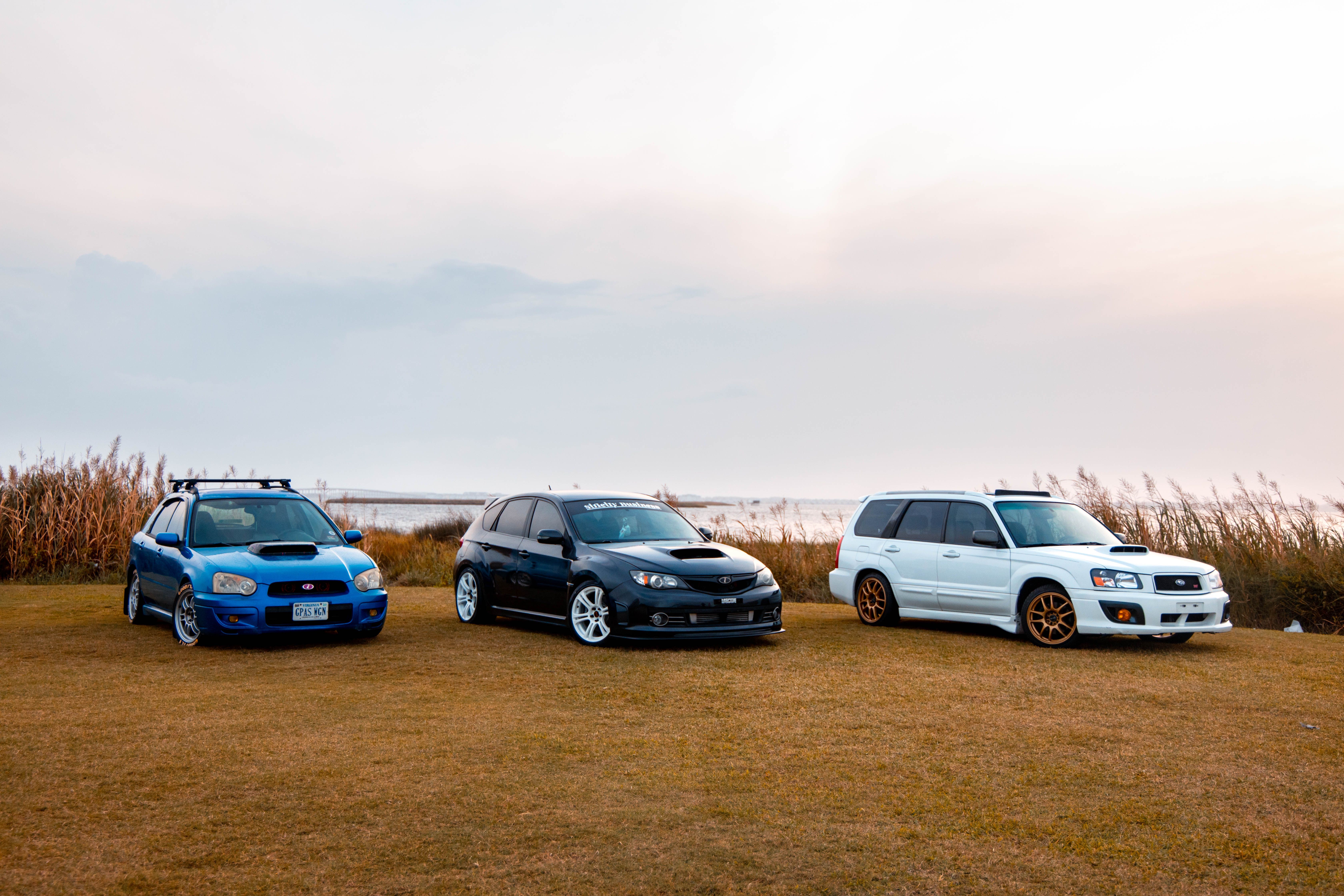 Three Cars Parked in Scenic Outdoor Setting · Free Stock Photo