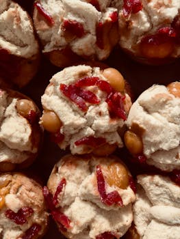 A top view of traditional steamed muffins with red and brown toppings.