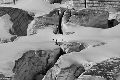 Free Three climbers navigating the icy crevasses of Chamonix-Mont-Blanc, France. Stock Photo