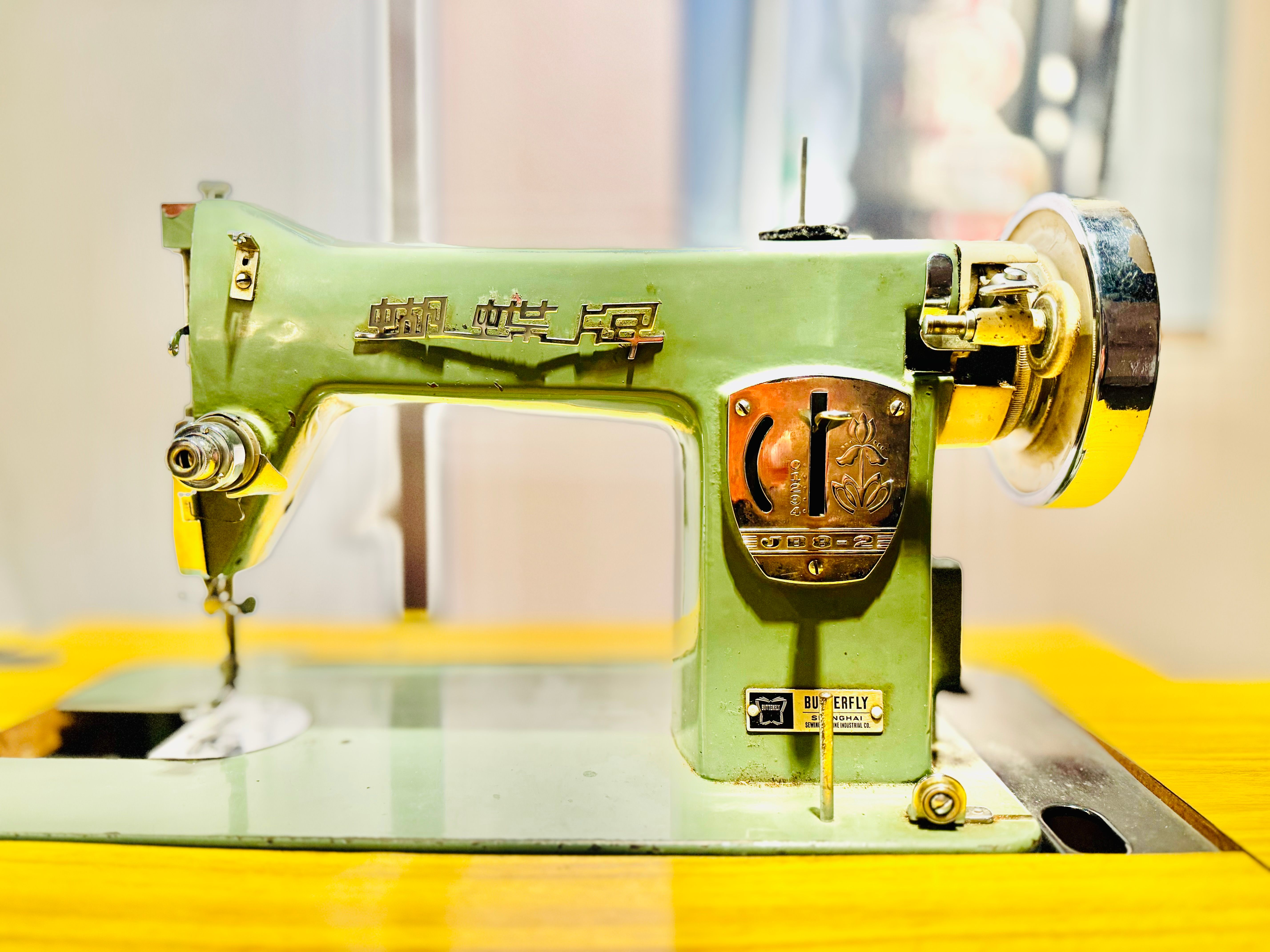 Detailed view of a classic green sewing machine with vintage design. — Maynard Longarm Quilting