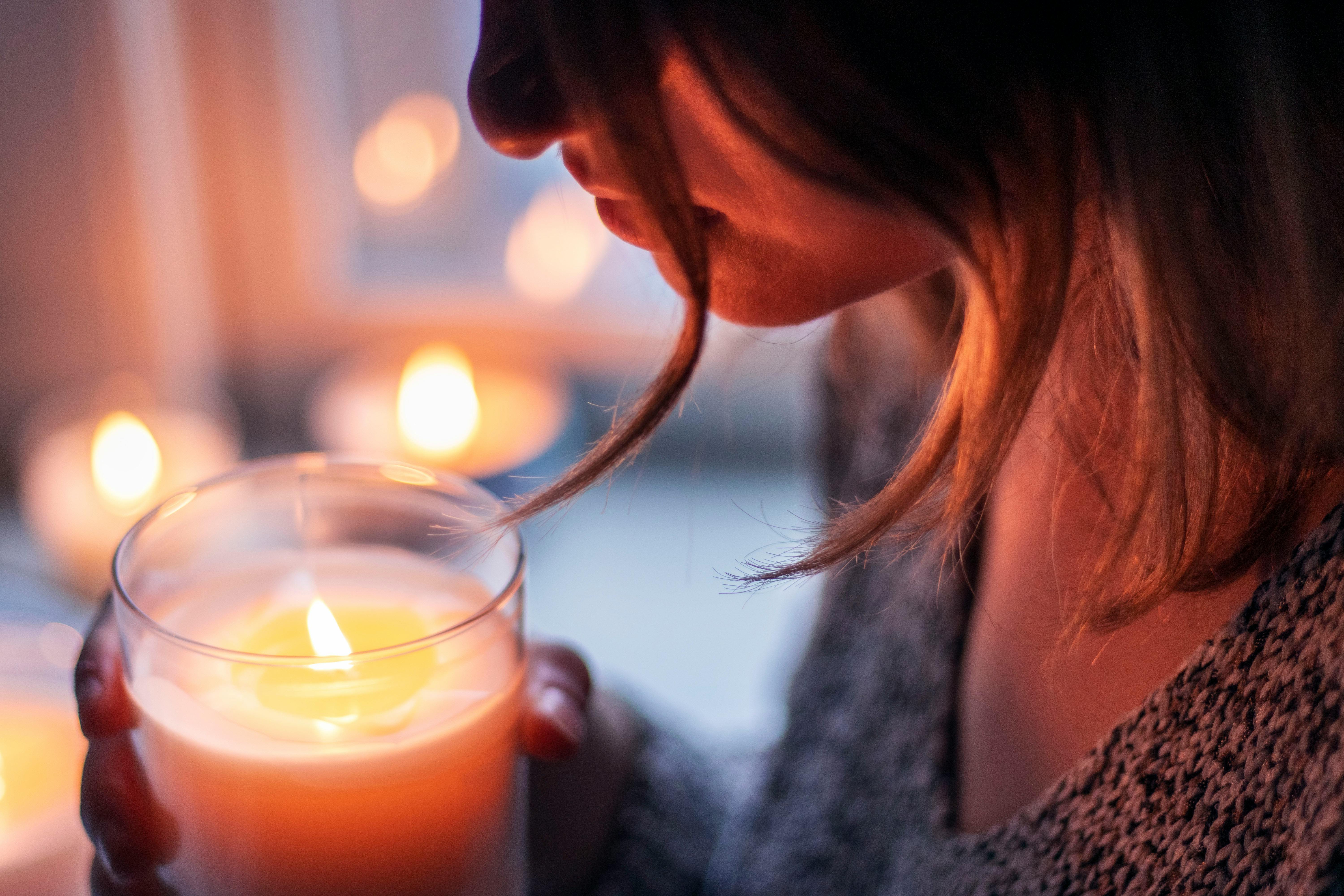 Woman Holding Lighted Votive Candle · Free Stock Photo