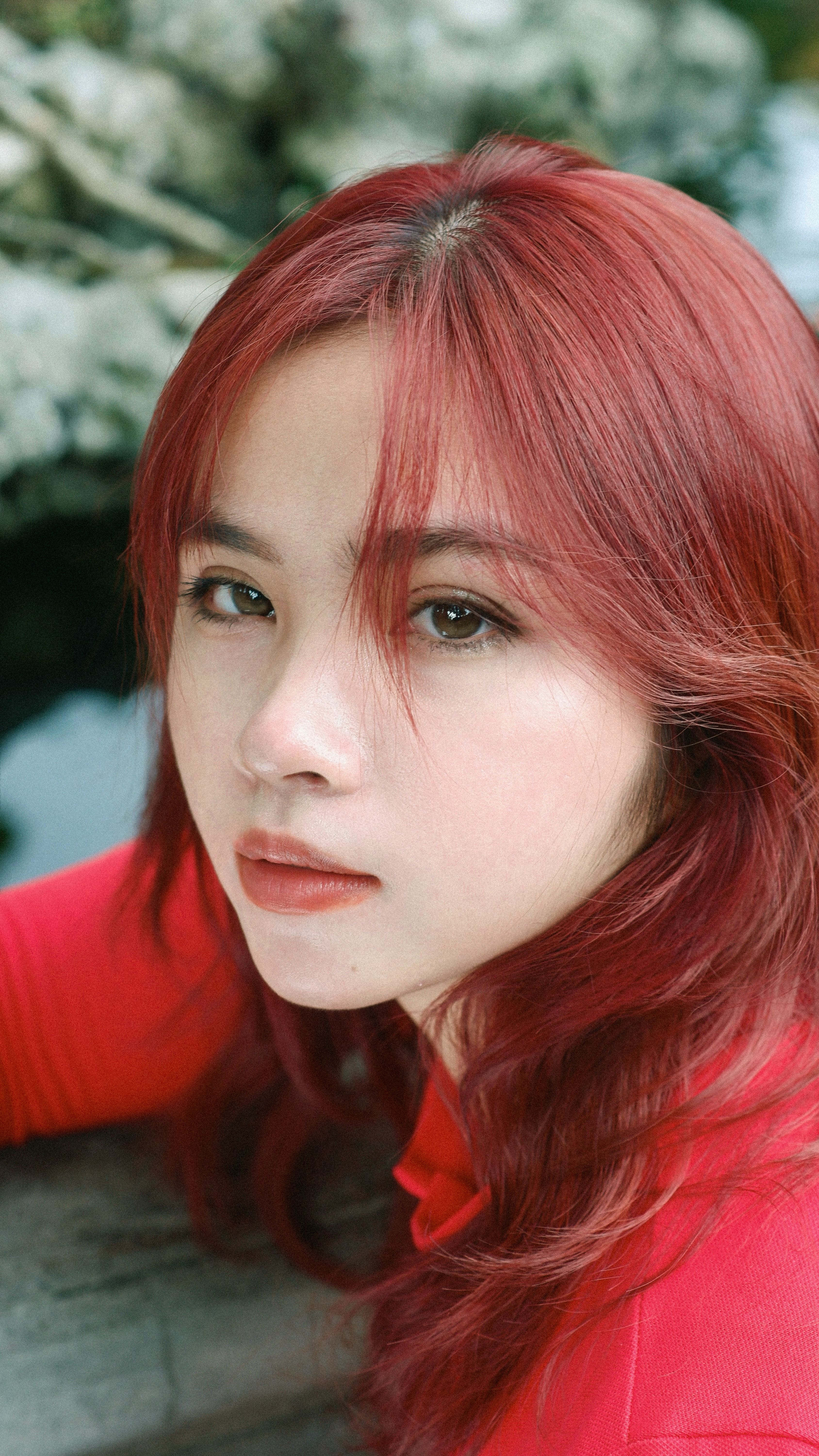 Portrait of a woman with vibrant red hair outdoors · Free Stock Photo