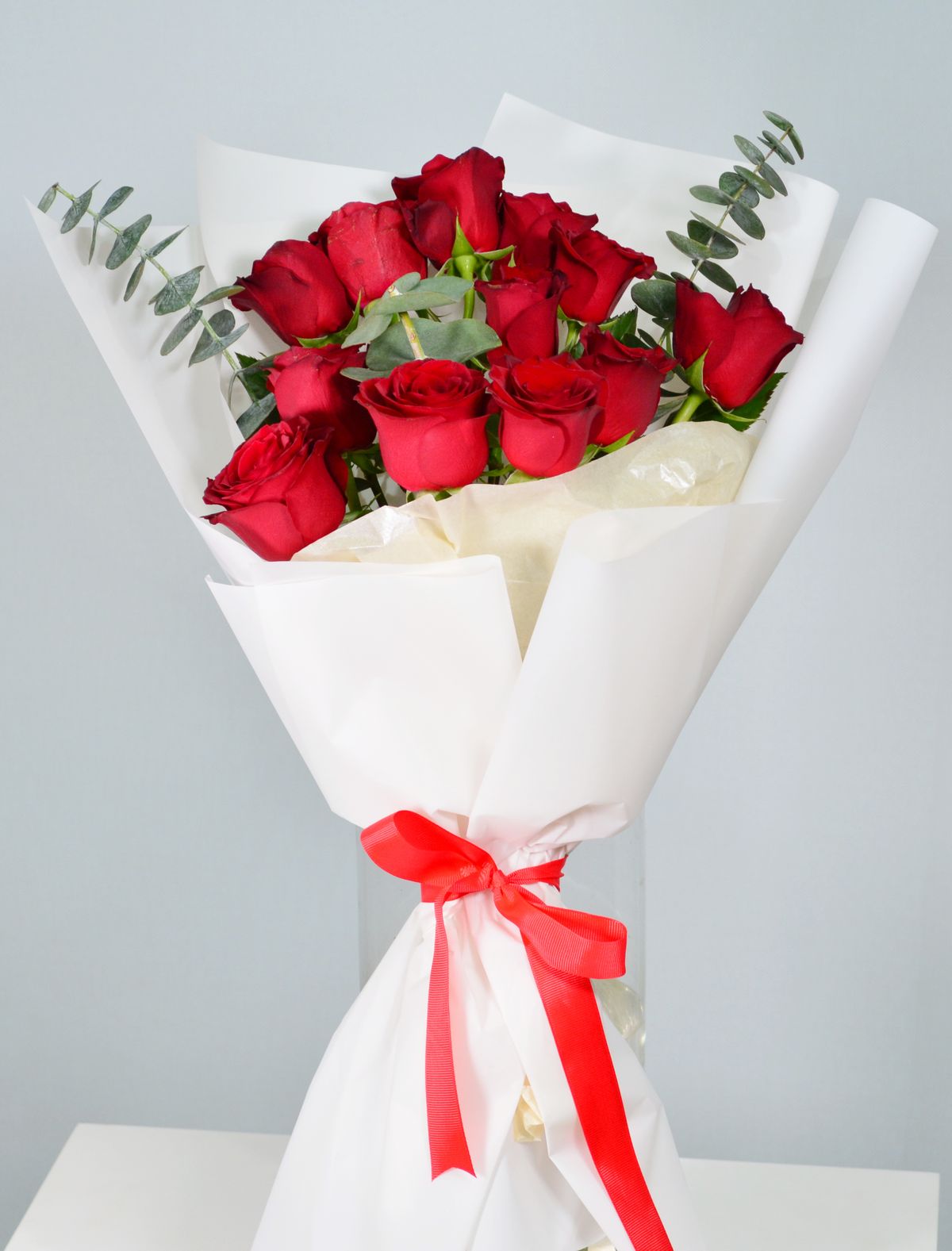 Elegant red rose bouquet wrapped with red ribbon