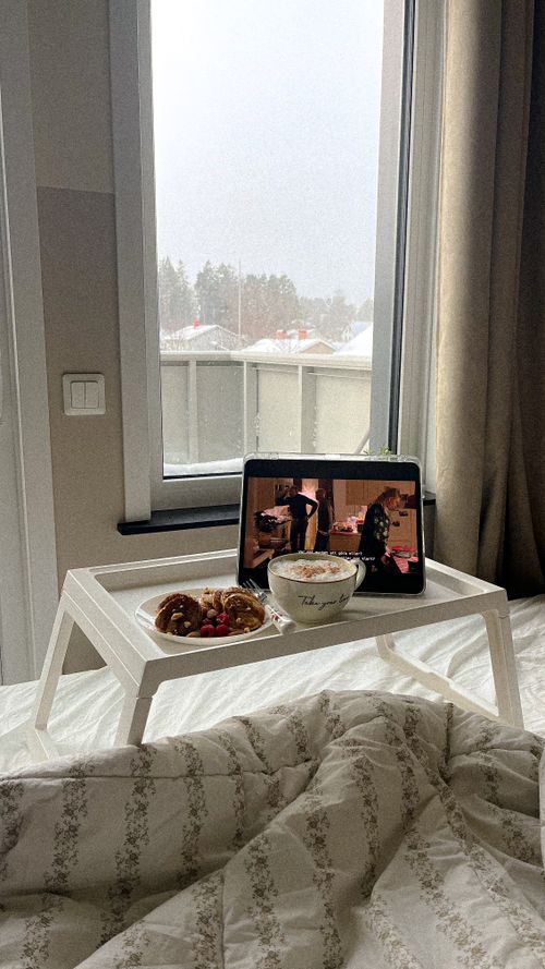 Free A cozy winter morning in Stockholm with breakfast and a tablet on a bed. Stock Photo