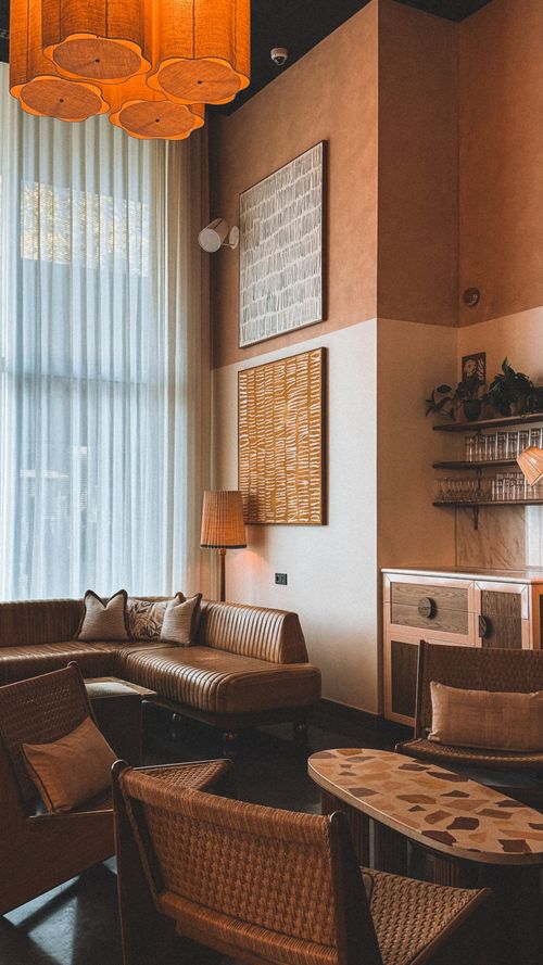 Free Stylish living room featuring modern amenities, warm earth tones, and natural lighting. Stock Photo