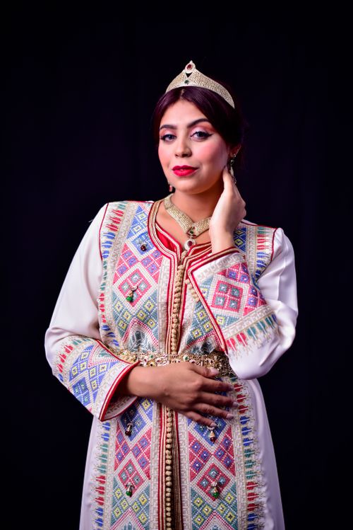 Free Portrait of a woman in Moroccan traditional dress with intricate embroidery. Stock Photo