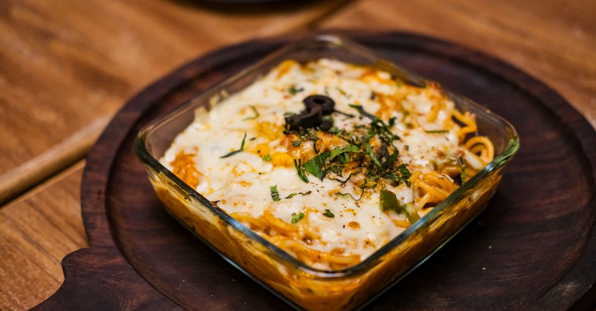 Delicious baked pasta with cheese and herbs, captured in Mumbai, India.