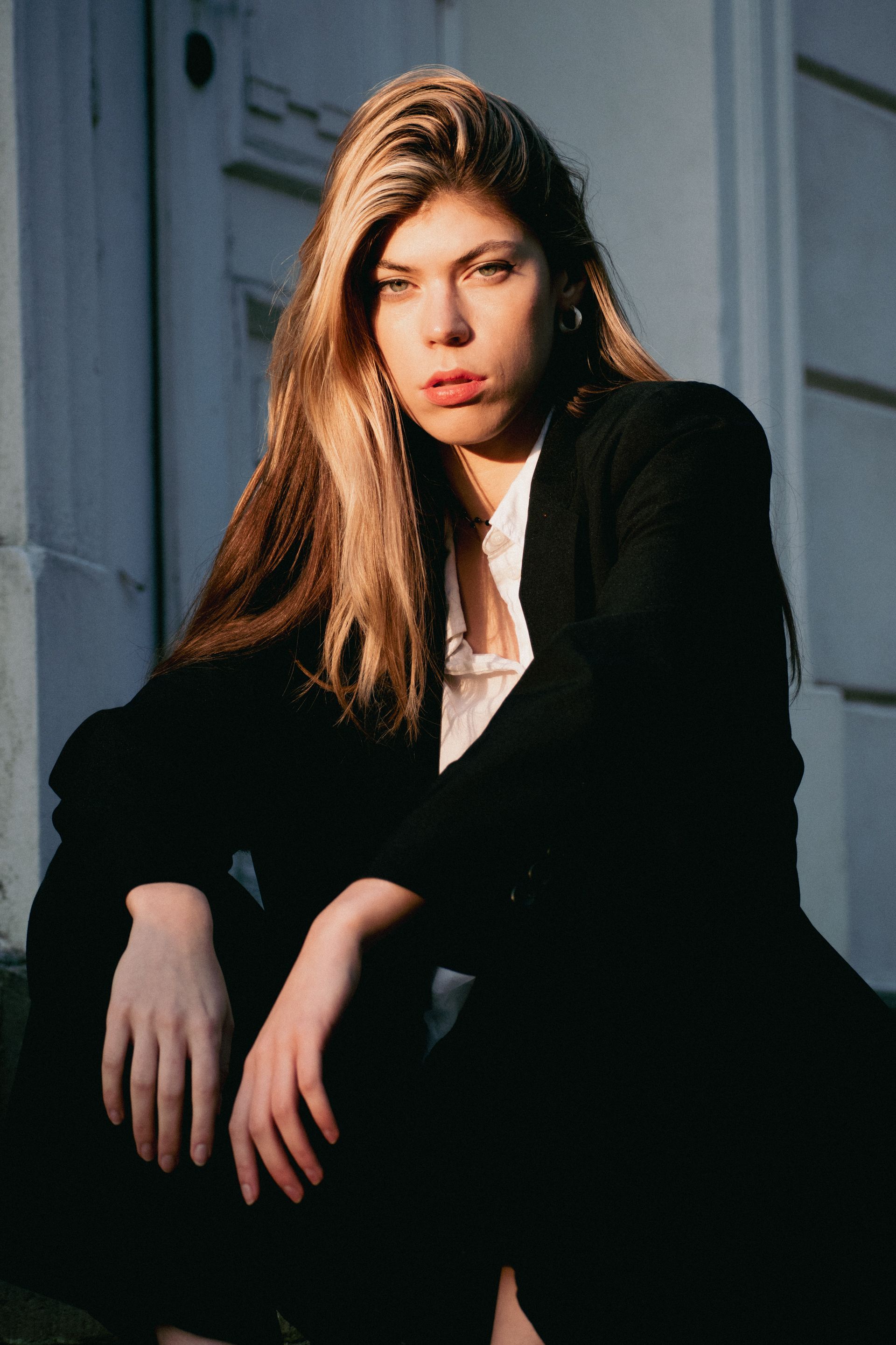 Stylish woman posing in natural light, showcasing elegance and confidence.