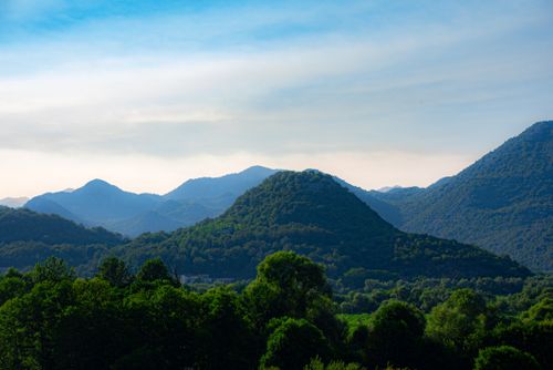 Free Scenic view of lush greenery and rolling mountains under a clear blue sky in Montenegro. Stock Photo