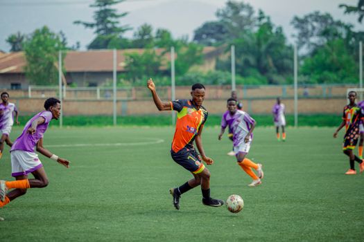 Intense soccer match action with young players competing on the field.