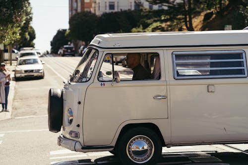 Man Driving An Old White Volkswagen  Kombi