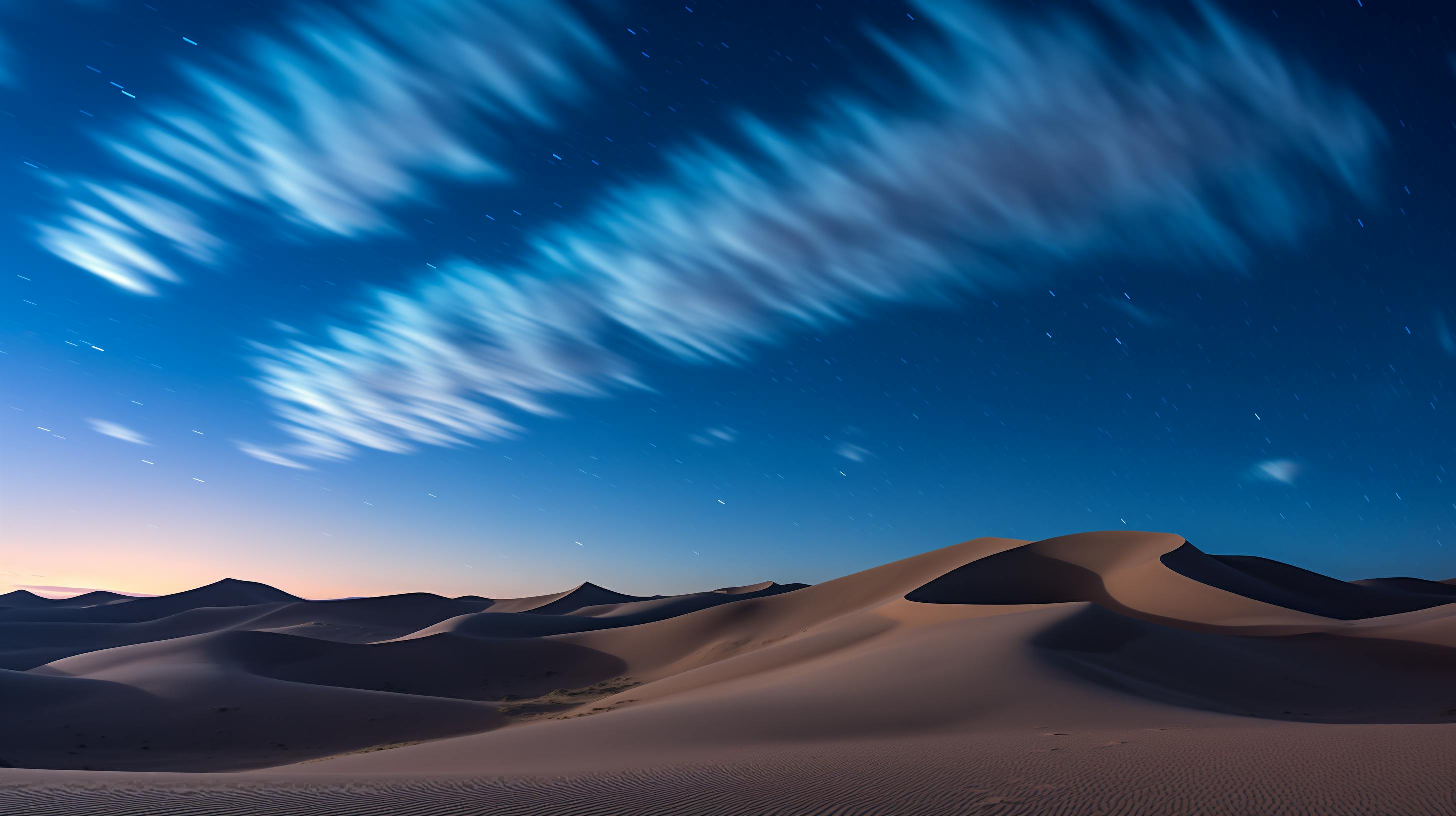 A mesmerizing night sky above tranquil sand dunes in a desert landscape.