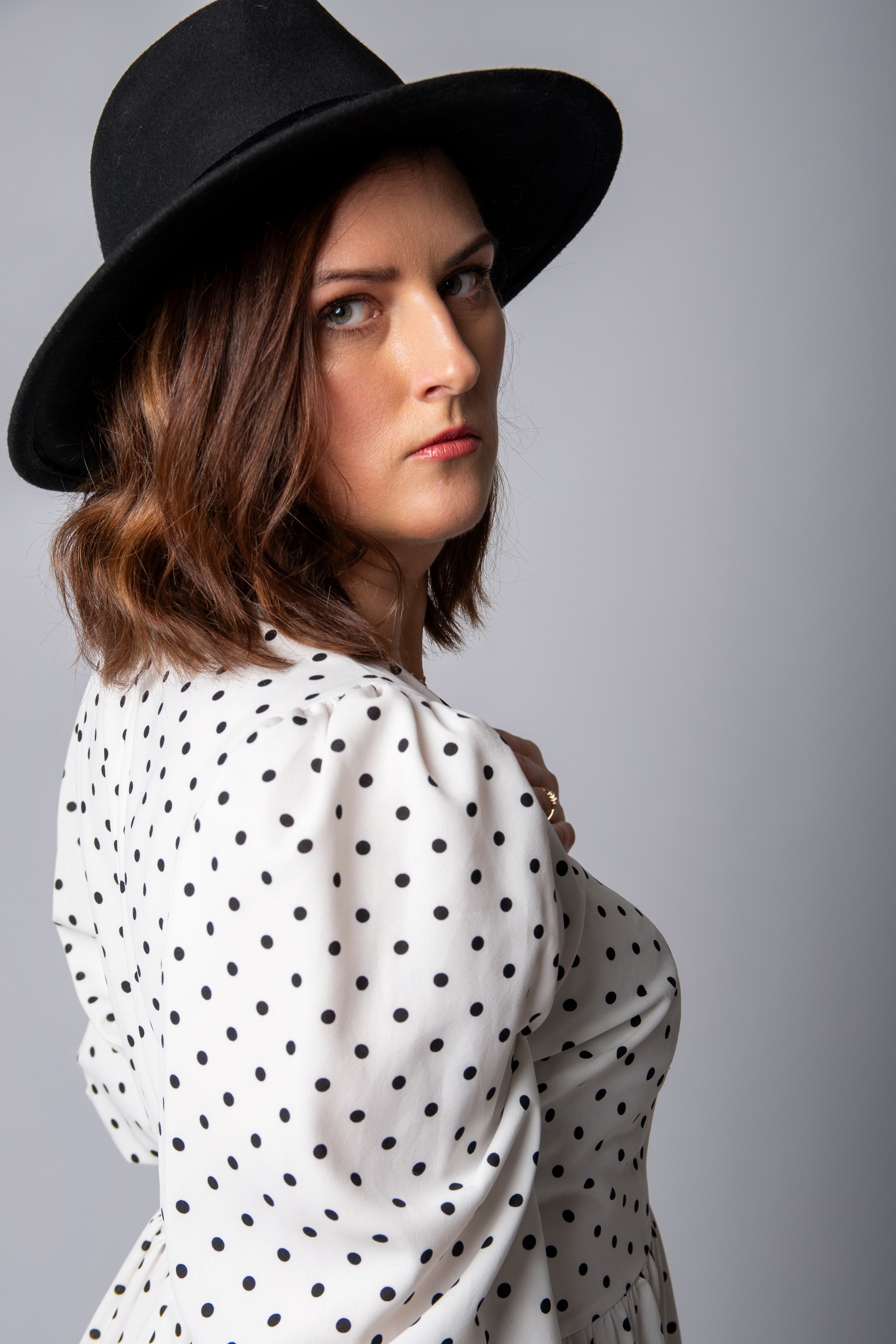 Stylish Portrait of a Woman in Polka Dot Dress · Free Stock Photo