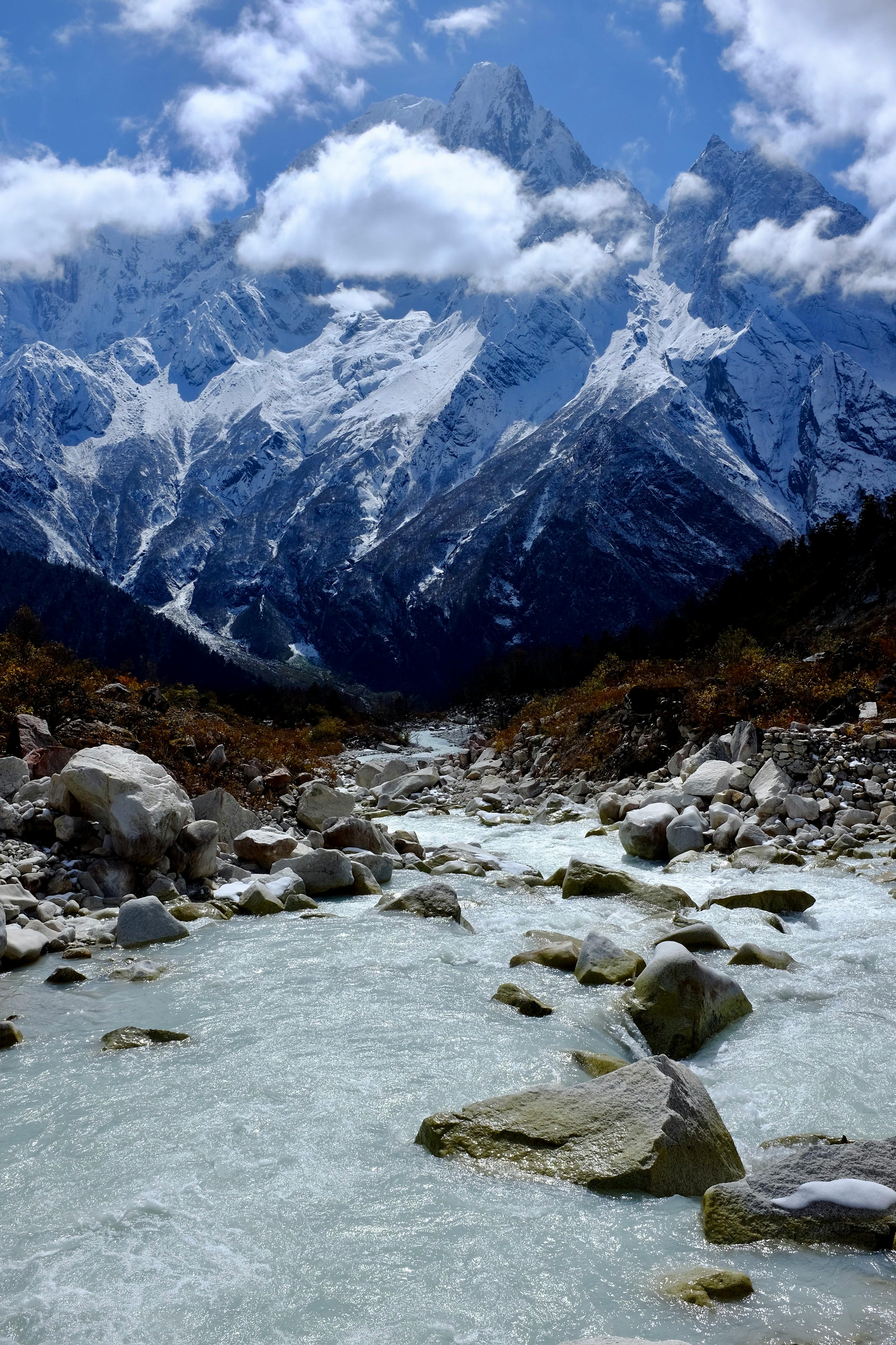 Breathtaking view of the snow-capped Himalayan mountains with a flowing river.