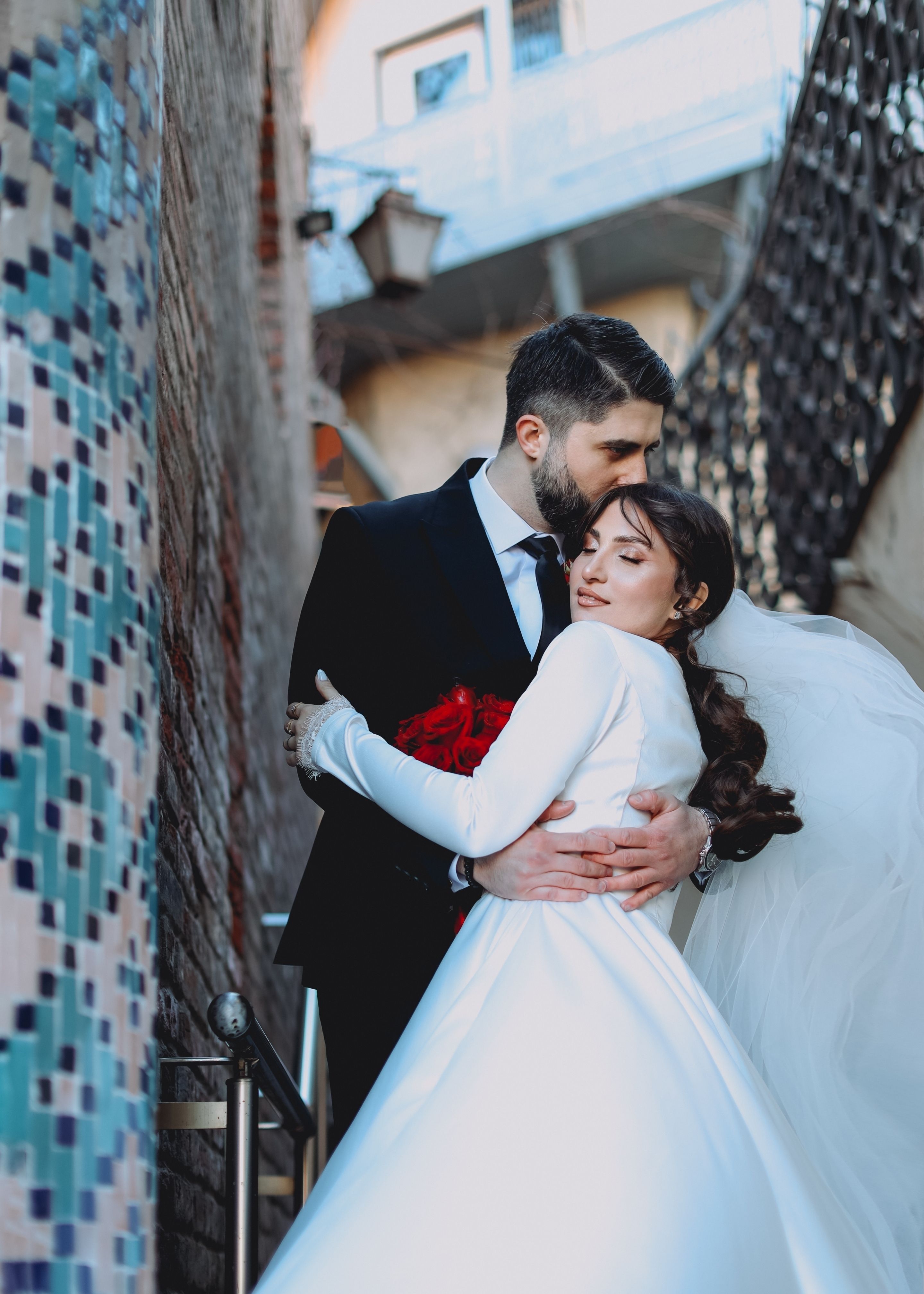 Romantic Wedding Couple Embrace on Staircase · Free Stock Photo