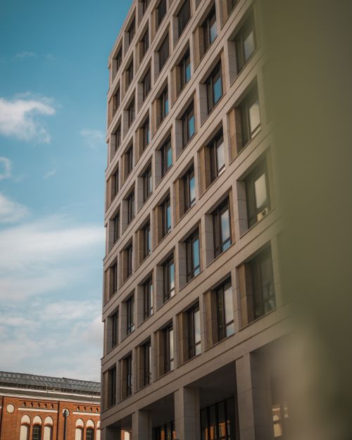 Free Angle view of a modern office building in Berlin with a clear blue sky. Stock Photo