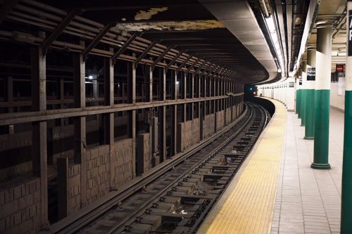 Free Deserted subway platform with a curved tunnel and tracks. Stock Photo