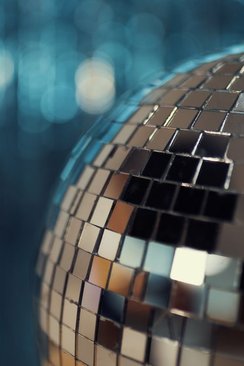 Free Vibrant close-up of a glistening disco ball reflecting colorful lights against a blurred background. Stock Photo
