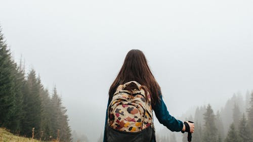 Free Woman With Backpack Standing Near Trees Stock Photo