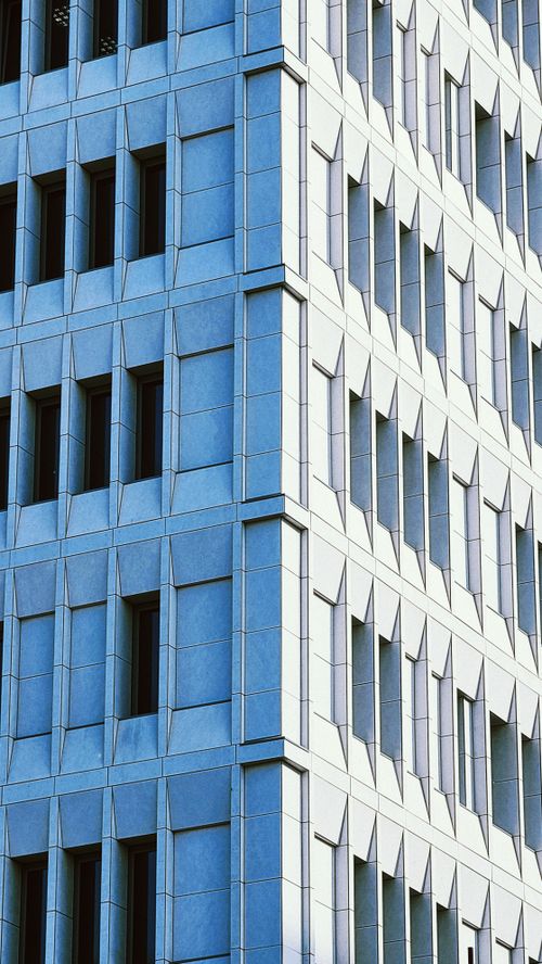 Free Abstract view of a modern brutalist building facade showcasing geometric patterns and shadows. Stock Photo