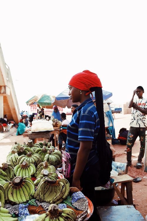 A bustling street market scene in Nigeria, representing the vibrant commerce in places like Onitsha Main Market.