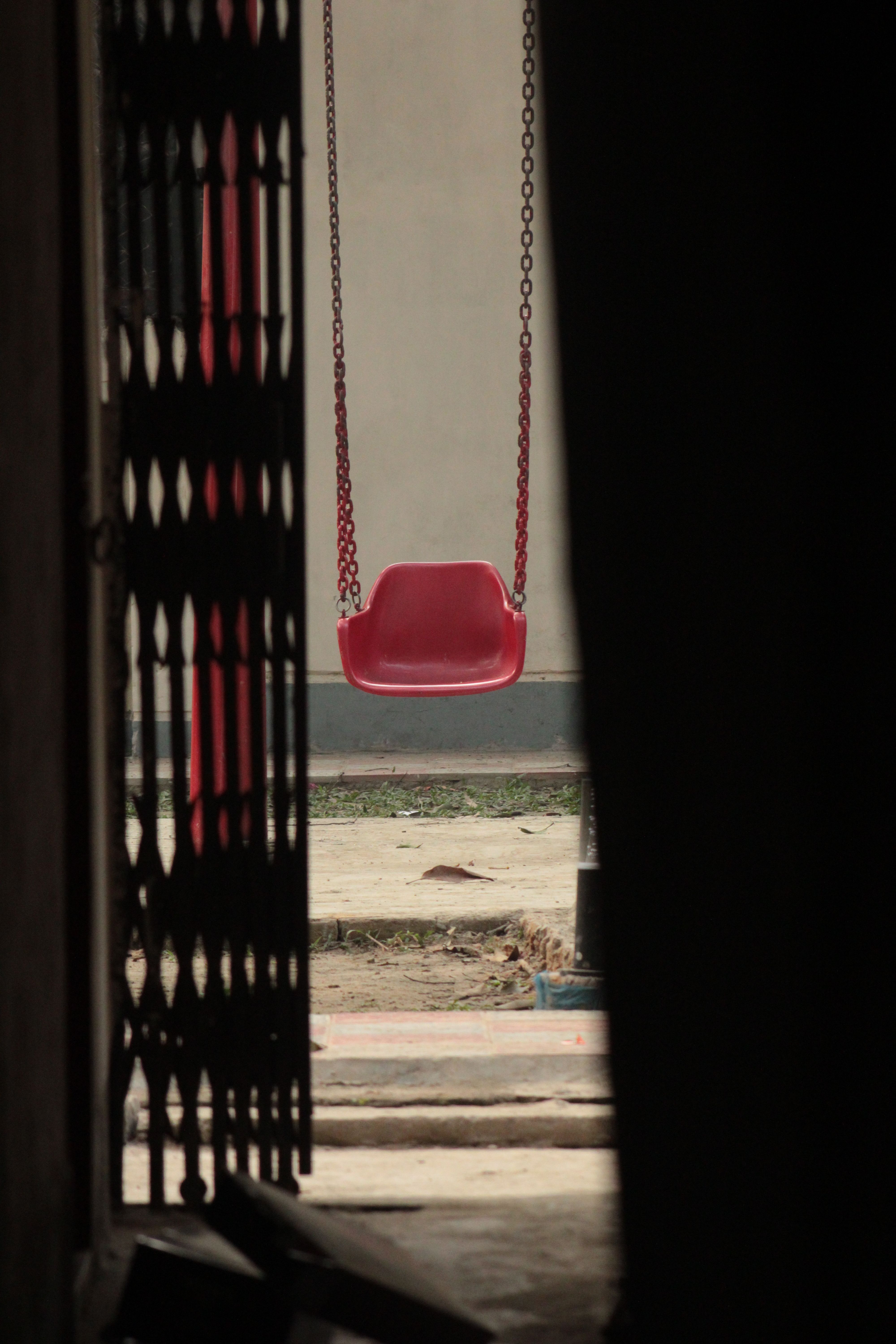 Lonely Red Swing in Playground Entrance · Free Stock Photo