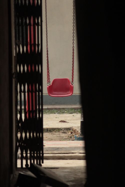 Lonely Red Swing in Playground Entrance · Free Stock Photo