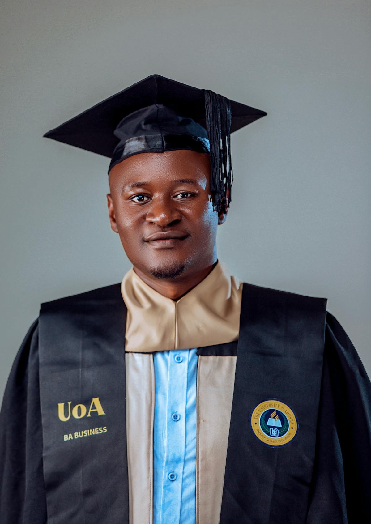 A Graduate Wearing a Mortarboard and a Graduation Gown · Free Stock Photo