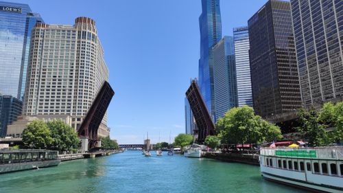 Free Vibrant view of Chicago River with raised bridges and city skyscrapers under a clear sky. Stock Photo