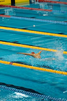 Swimmer in action during a competition in Ankara's indoor pool.