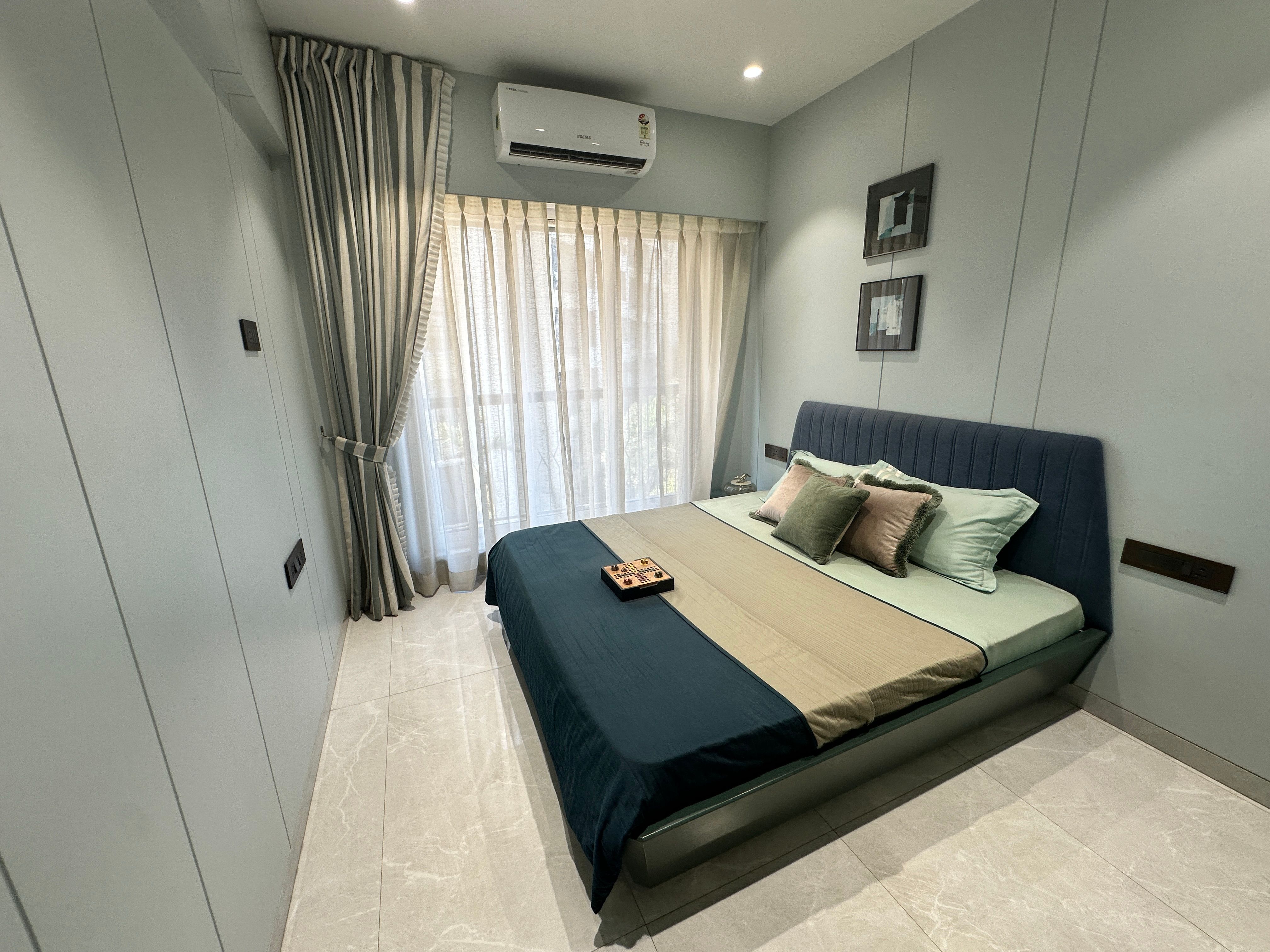 Person selecting foldable bed in modern Mumbai home