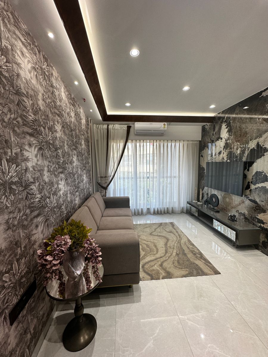 Contemporary Indian living room with patterned wall, warm neutral seating and natural light