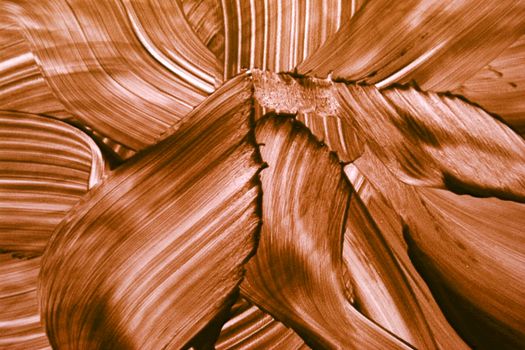 Close-up of abstract brown brushstroke texture creates artistic visual pattern.