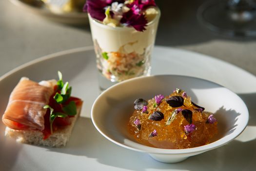 A curated assortment of gourmet desserts with fresh flowers for an elegant dining experience.