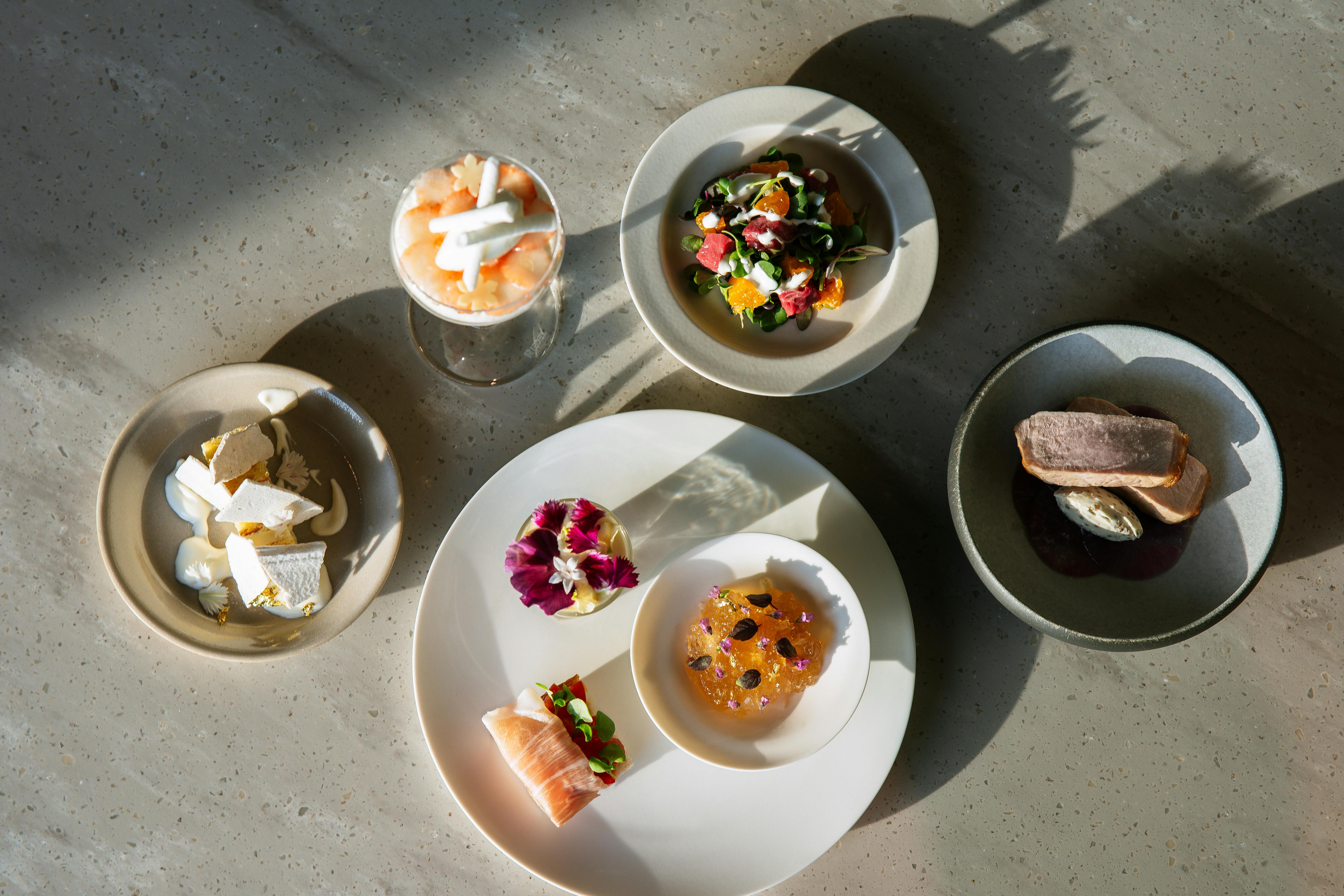 Aerial view of a variety of gourmet dishes with creative presentation, perfect for culinary enthusiasts.