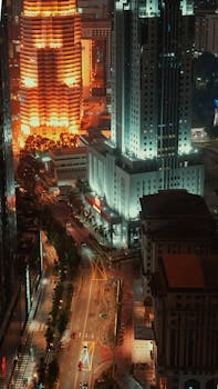 Stunning aerial view of Kuala Lumpur's illuminated skyline, showcasing vibrant nightlife.