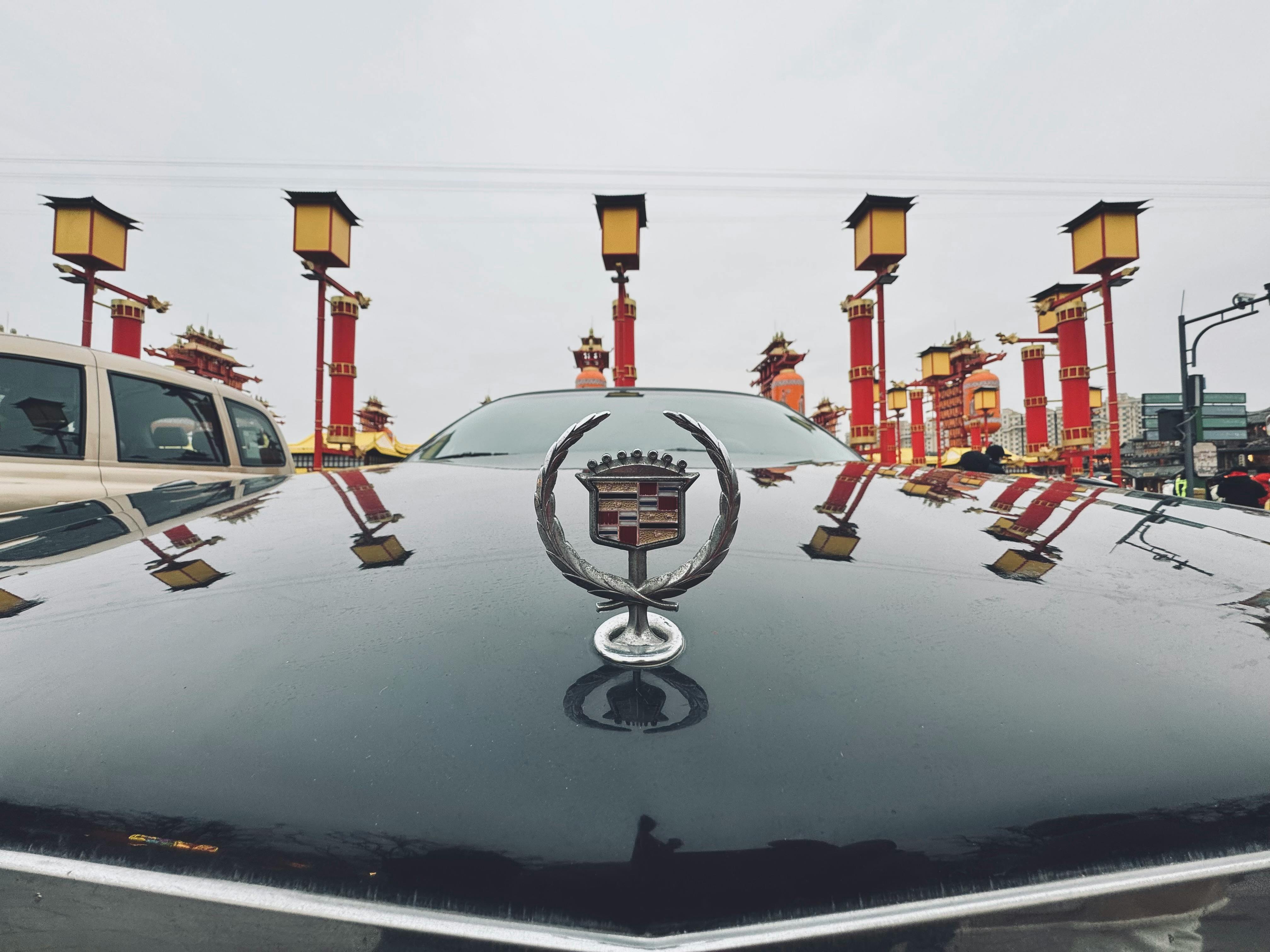 front view of a classic car in a vibrant cityscape