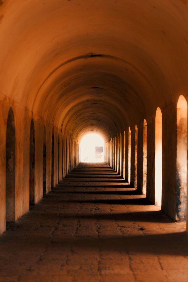 Light cutting through an arched passage — photo by Abhinav Ravindran on Pexels