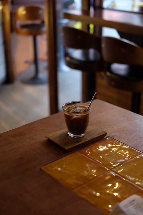 Free Warm cafe ambiance with iced coffee on a wooden table. Stock Photo
